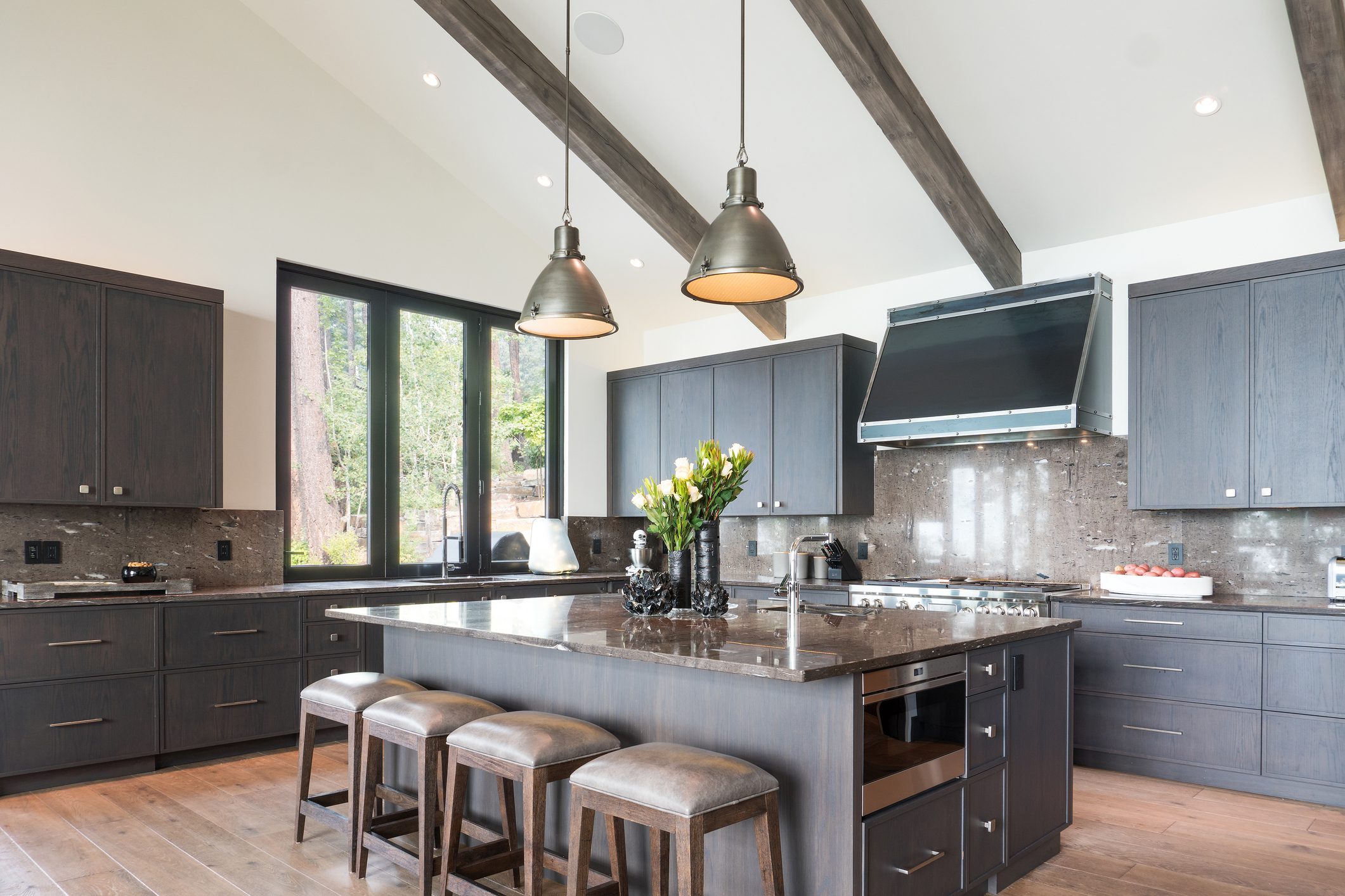 Modern kitchen with island and wooden beams.