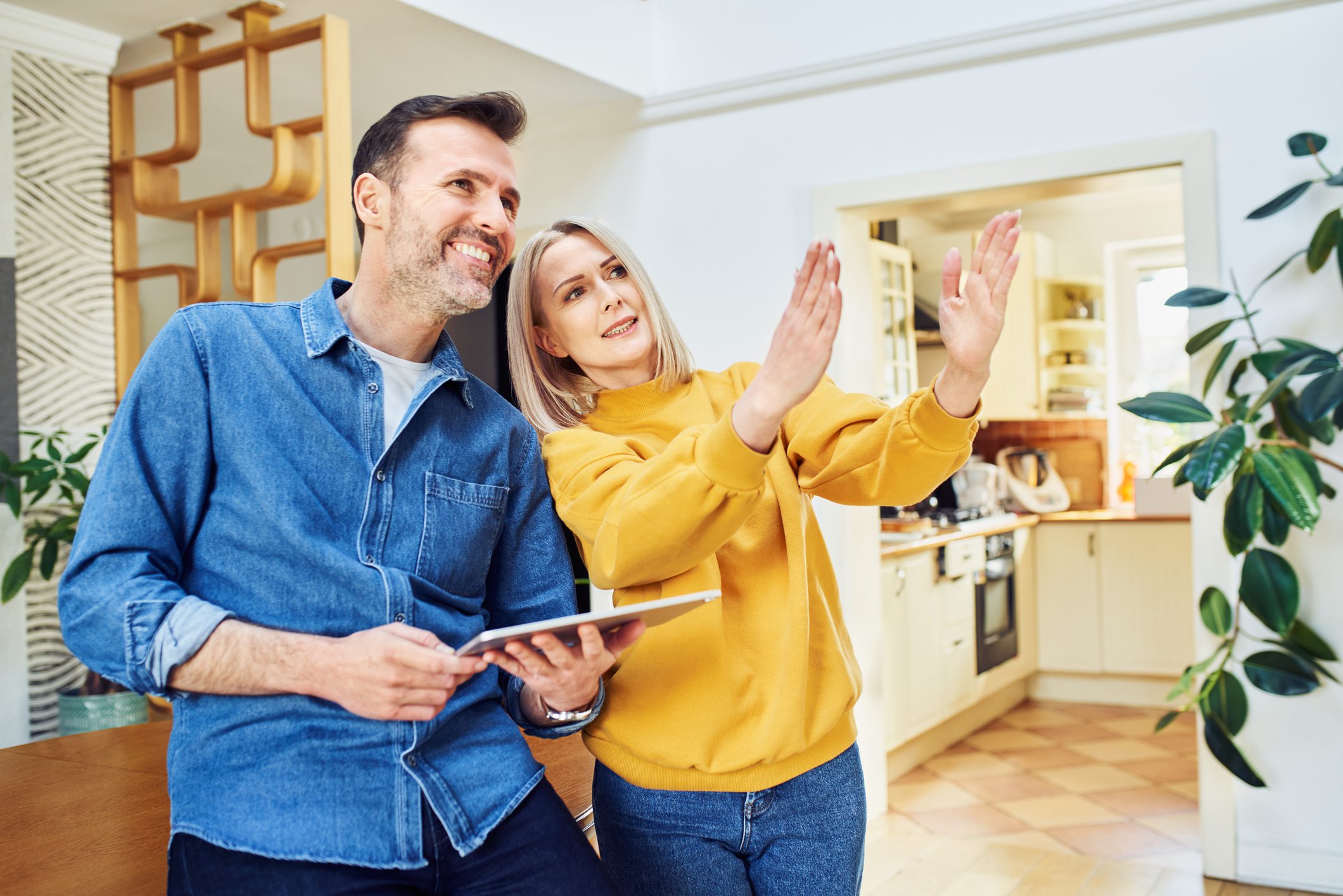 Couple discussing plans in modern kitchen setting.