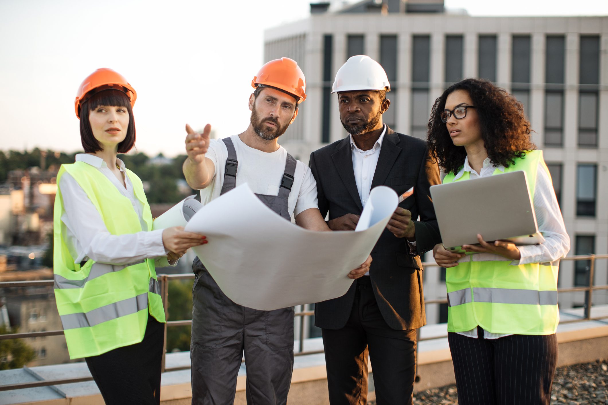 Construction team reviewing blueprints on site.